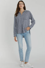 Load image into Gallery viewer, Woman wearing a checkered shirt and light blue jeans on a white background