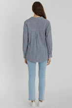 Load image into Gallery viewer, Person wearing a black and white checkered shirt and light blue jeans on a plain background