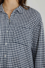 Load image into Gallery viewer, Close-up of a person wearing a black and white checkered shirt against a neutral background