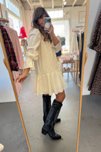 Load image into Gallery viewer, Person wearing a white dress and black knee-high boots in a store setting.