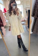 Load image into Gallery viewer, Person wearing a cream dress and black boots in a clothing store.