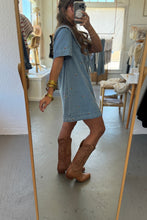 Load image into Gallery viewer, Person taking a mirror selfie wearing a denim dress and brown boots in a room.