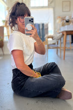 Load image into Gallery viewer, Person taking a mirror selfie in a casual setting