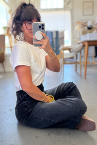 Person taking a mirror selfie in a casual setting
