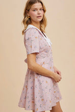 Load image into Gallery viewer, Woman wearing a floral dress on a beige background
