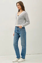 Load image into Gallery viewer, Woman wearing a striped sweater and blue jeans against a white background