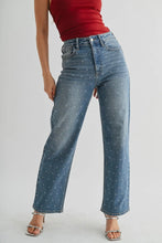 Load image into Gallery viewer, Person wearing blue jeans with white speckles on a plain background