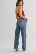 Load image into Gallery viewer, Woman wearing a strapless red top and blue jeans on a white background