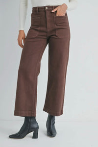 Brown pants worn by a person on a white background