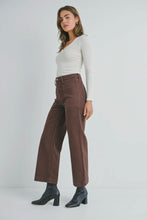 Load image into Gallery viewer, Woman wearing a white top and brown pants on a white background