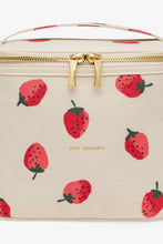 Load image into Gallery viewer, A rectangular cream-colored cosmetic bag with a repeating red strawberry pattern, gold-tone zipper, and a top handle, shown against a plain white background.