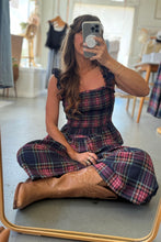 Load image into Gallery viewer, Woman taking a mirror selfie wearing a plaid dress and brown boots in a room.