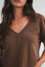 Load image into Gallery viewer, Woman wearing a brown V-neck t-shirt against a neutral background