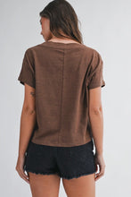 Load image into Gallery viewer, A woman shown from the back wearing a brown short-sleeve crop top and dark denim shorts against a light gray studio background.