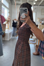 Load image into Gallery viewer, Person taking a mirror selfie wearing a plaid dress in a clothing store.
