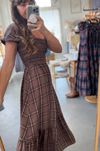 Load image into Gallery viewer, Woman wearing a brown plaid dress in a store setting