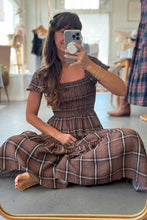 Load image into Gallery viewer, Woman sitting on the floor wearing a plaid dress, taking a mirror selfie.