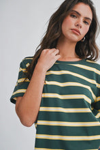 Load image into Gallery viewer, A woman wearing a dark green short-sleeve t-shirt with horizontal yellow stripes, photographed against a light gray studio background.