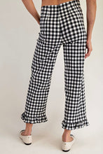 Load image into Gallery viewer, Black and white gingham cropped pants with ruffled hems, shown on a model from the back against a plain light background.