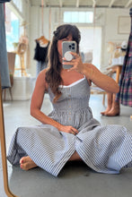 Load image into Gallery viewer, Woman taking a mirror selfie wearing a striped dress in a store.