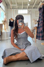 Load image into Gallery viewer, Woman taking a mirror selfie wearing a striped dress and brown boots in a clothing store.