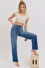 Load image into Gallery viewer, Woman wearing blue jeans and a beige crop top on a white background