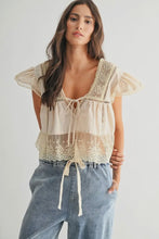 Load image into Gallery viewer, Woman wearing a lace top and jeans on a plain background