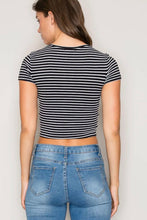 Load image into Gallery viewer, A woman shown from the back wearing a short-sleeve crop top with thin black and white horizontal stripes, paired with blue jeans, against a plain light gray background.