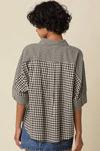 Load image into Gallery viewer, A woman shown from the back wearing a black and white gingham check shirt with three-quarter sleeves and denim shorts, set against a plain beige background.
