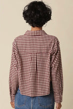 Load image into Gallery viewer, A person shown from the back wearing a long-sleeve red and white gingham check shirt with blue jeans, set against a plain beige background.