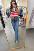 Load image into Gallery viewer, A woman takes a mirror selfie in a clothing boutique, wearing a red and white striped short-sleeve t-shirt and high-waisted, straight-leg blue jeans.