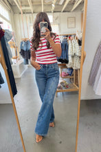Load image into Gallery viewer, A woman takes a mirror selfie in a clothing boutique, wearing a red and white striped short-sleeve t-shirt and high-waisted, wide-leg blue denim jeans.