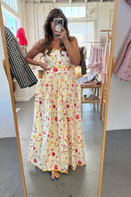 Load image into Gallery viewer, Woman wearing a floral dress in a store setting