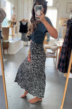 Load image into Gallery viewer, Person taking a mirror selfie wearing a black floral skirt and dark top in a clothing store.