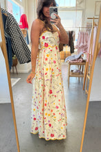 Load image into Gallery viewer, Person wearing a floral dress in a clothing store.