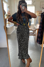 Load image into Gallery viewer, Person taking a mirror selfie wearing a black floral dress in a clothing store.