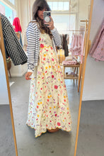 Load image into Gallery viewer, Person wearing a floral dress in a store setting