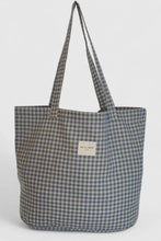 Load image into Gallery viewer, Gray and white checkered tote bag with a visible brand label on a light gray background