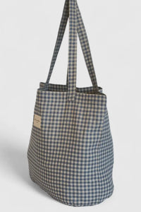 Checkered tote bag with a strap on a light gray background