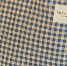 Load image into Gallery viewer, Blue and beige checkered fabric with a brand label in the corner.