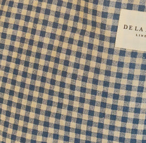 Blue and beige checkered fabric with a brand label in the corner.