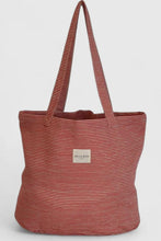 Load image into Gallery viewer, Red and white striped tote bag with a visible brand label on a light gray background