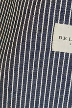 Load image into Gallery viewer, Close-up of a navy and white striped fabric with a label in the corner.