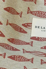 Load image into Gallery viewer, Fabric with red fish pattern and &#39;De La&#39; label on beige background