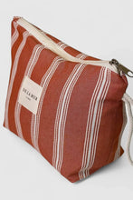 Load image into Gallery viewer, Striped fabric pouch with a visible brand label on a light gray background