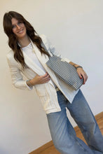 Load image into Gallery viewer, Woman holding a checkered handbag against a plain background