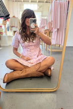Load image into Gallery viewer, Person sitting on the floor in front of a mirror wearing a pink dress and brown cowboy boots.