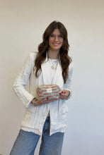 Load image into Gallery viewer, Woman holding a small bag against a plain background