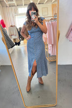 Load image into Gallery viewer, Woman taking a mirror selfie wearing a blue dress in a clothing store.