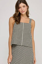 Load image into Gallery viewer, Woman wearing a black and white checkered dress on a plain background